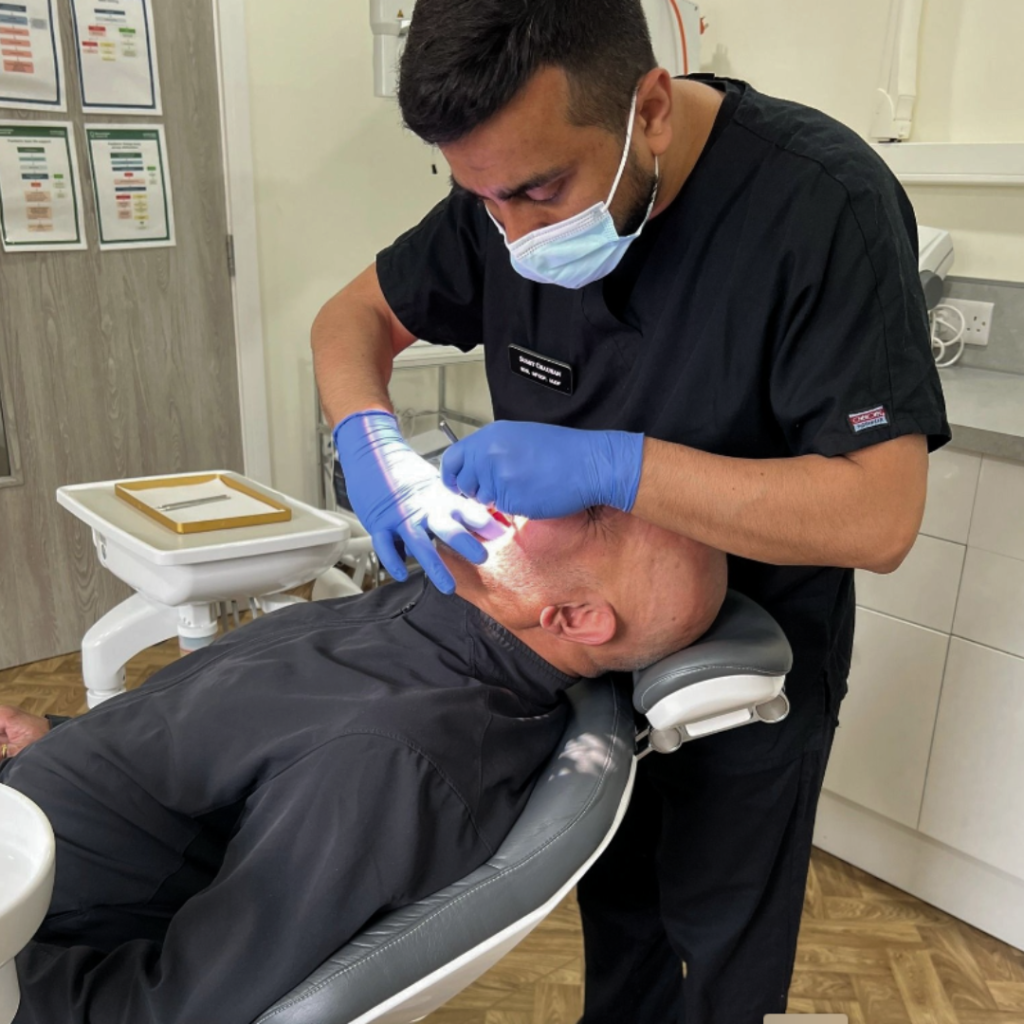 Dentist at Smile Perfections in Oadby, Leicester treating a patient in the dental chair.